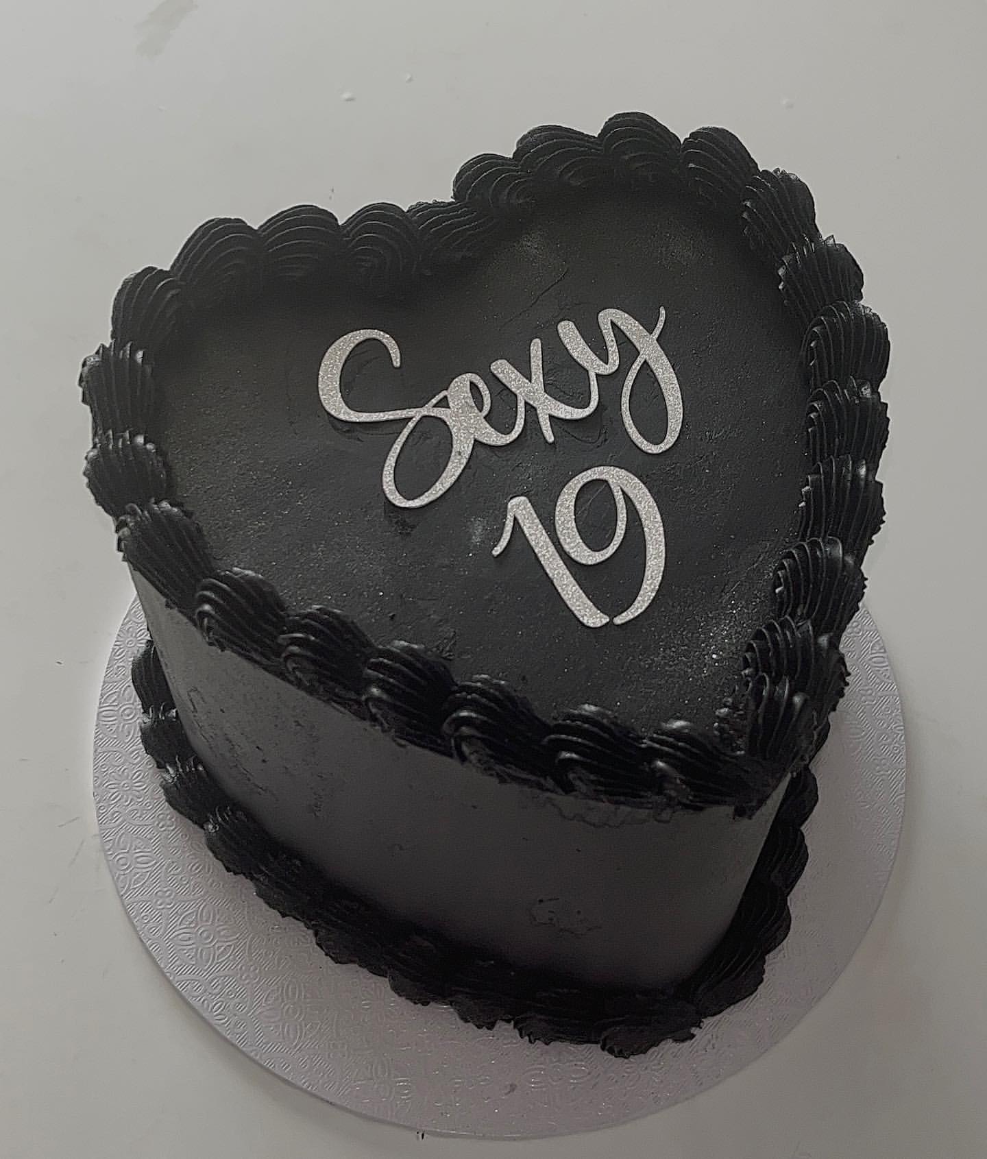 Black heart cake with silver 'Sexy 19' topper by The Cake Realm